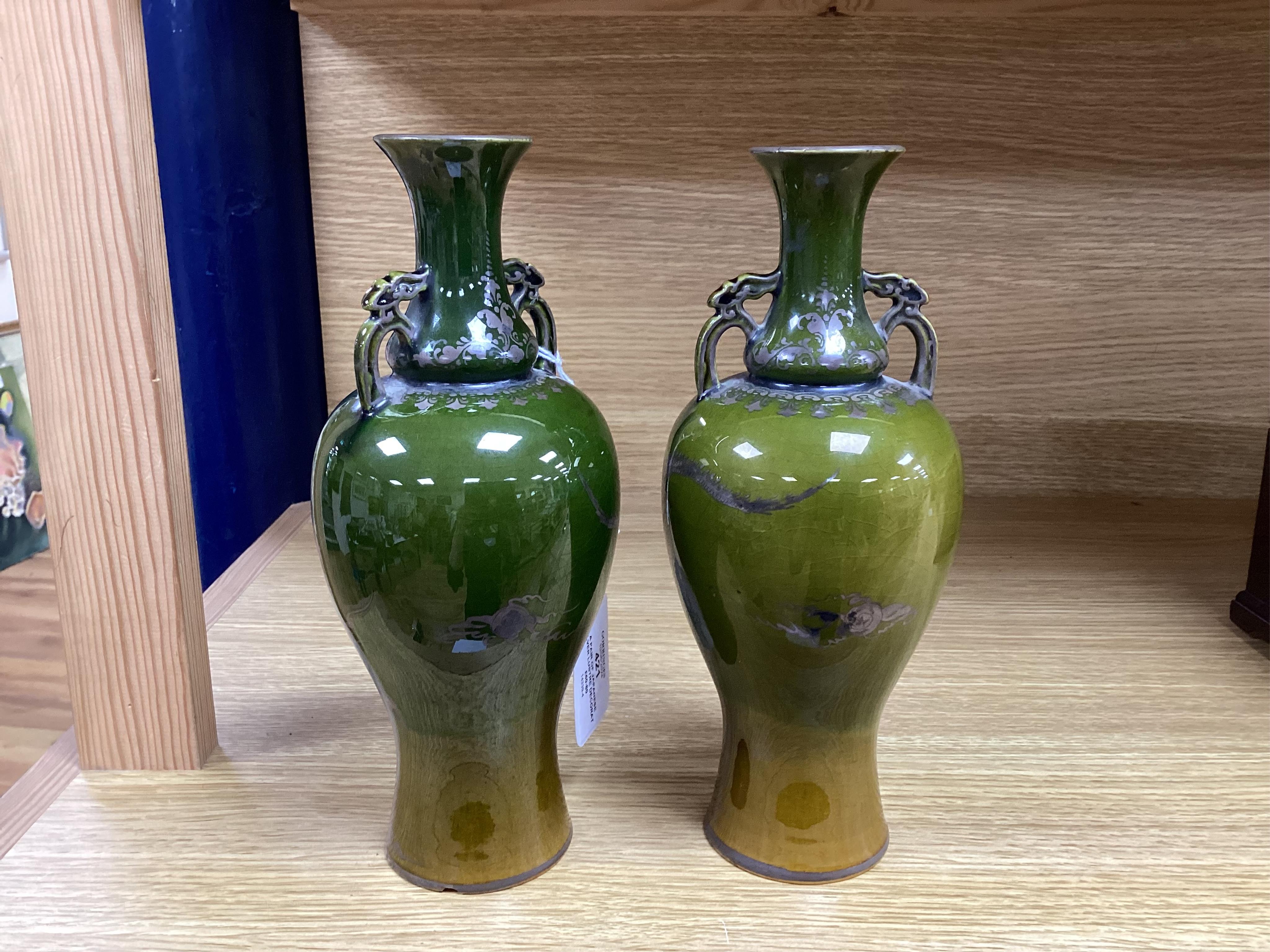 A pair of Japanese silver lustre decorated ‘dragon’ vases, 22.5cm